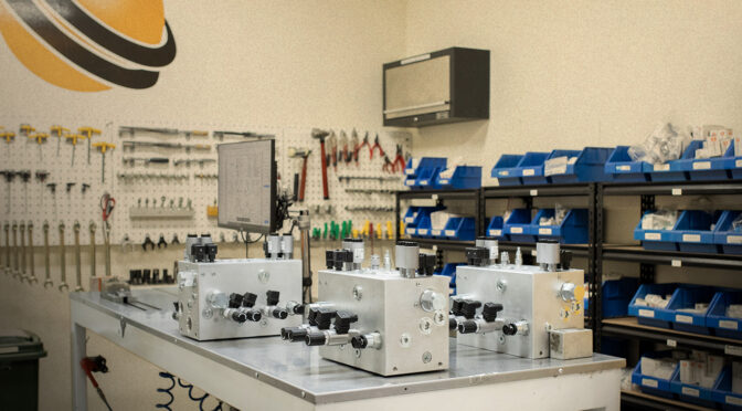 Three custom hydraulic manifolds engineered with different configurations for specific applications